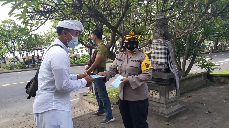 Wakapolres Klungkung Bagikan Masker Kepada Para Pemedek di Depan Pura Gua Lawah
